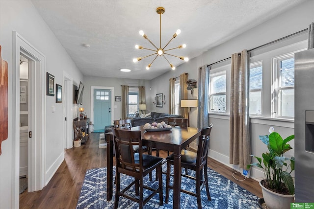 dining space with plenty of natural light, a textured ceiling, and dark hardwood / wood-style floors