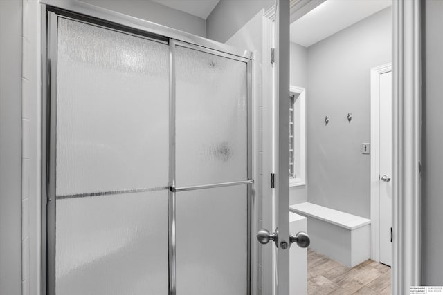 bathroom with wood-type flooring and walk in shower