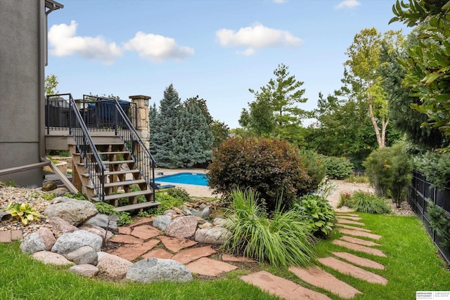 view of yard with a swimming pool side deck