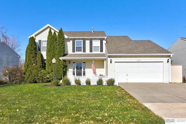 view of front of home with a garage and a front yard