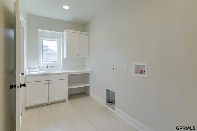 laundry room featuring hookup for an electric dryer, washer hookup, cabinets, and sink