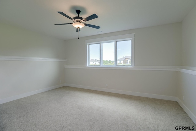 unfurnished room with carpet flooring and ceiling fan