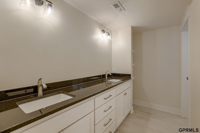 bathroom with tile patterned floors and vanity