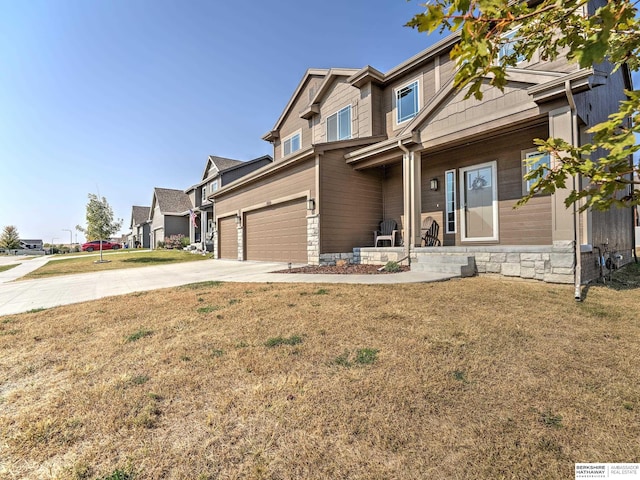 craftsman-style house with a garage and a front lawn