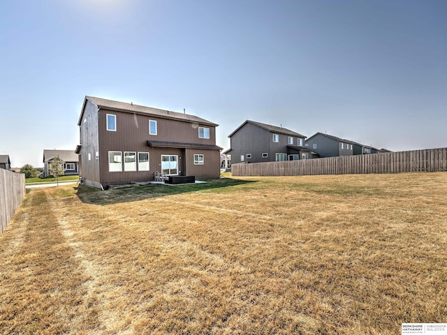 back of house featuring a lawn and central air condition unit