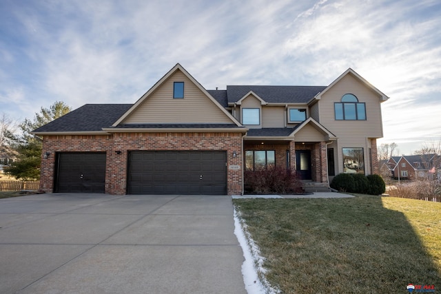 view of front of house with a garage and a front lawn