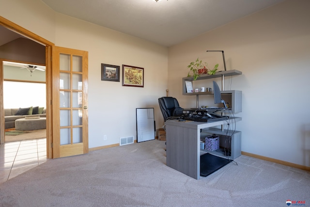 carpeted office space featuring french doors and ceiling fan