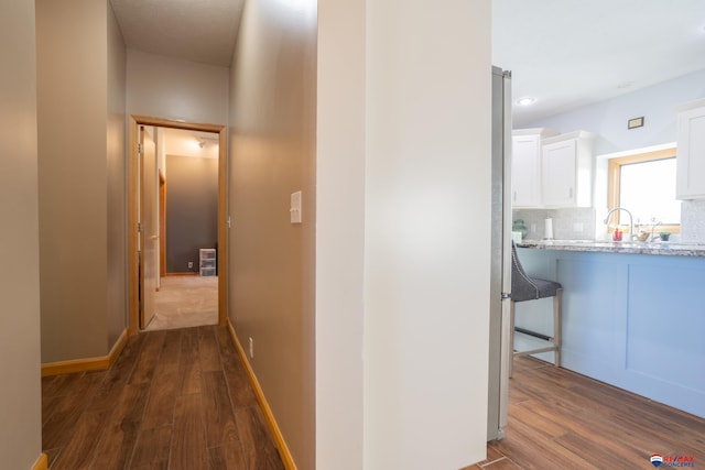 corridor featuring dark hardwood / wood-style floors and sink