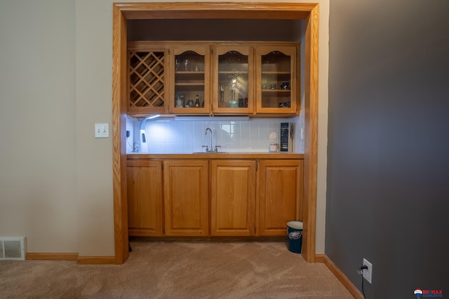 bar with tasteful backsplash, sink, and carpet floors