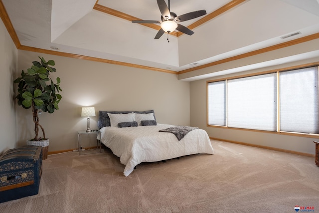 bedroom featuring carpet floors, a tray ceiling, ceiling fan, and ornamental molding