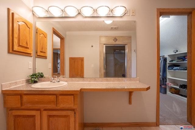 bathroom with tile patterned floors and vanity