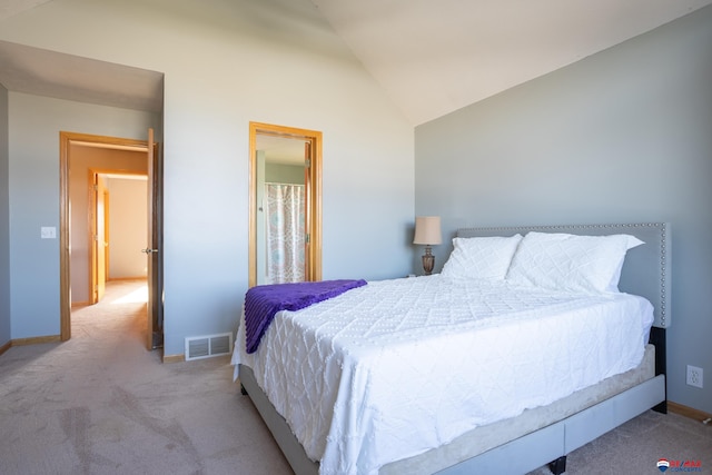 carpeted bedroom with lofted ceiling