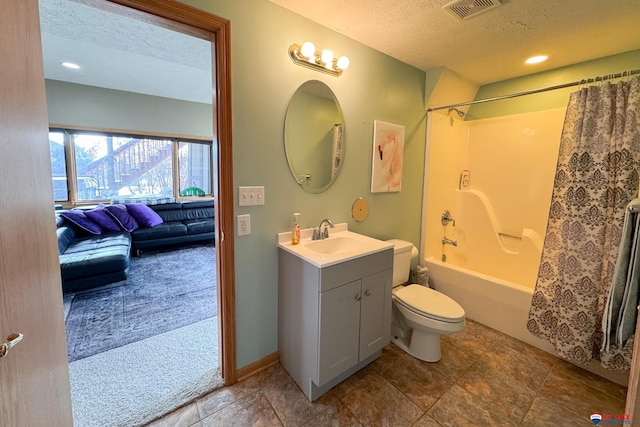 full bathroom with shower / bath combo with shower curtain, vanity, a textured ceiling, and toilet