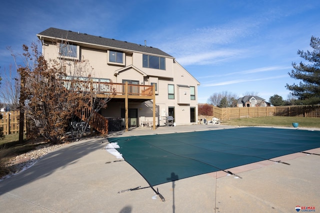 view of swimming pool featuring a patio area and a wooden deck