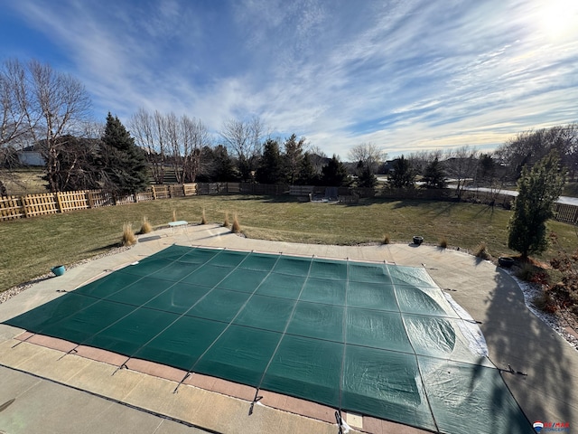 view of swimming pool featuring a lawn