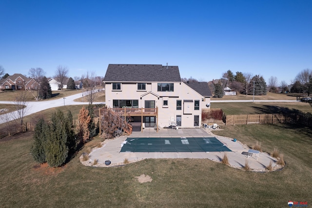 back of house with a pool side deck, a patio area, and a yard