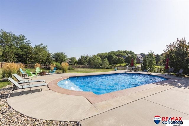 view of pool with a patio area and a fire pit