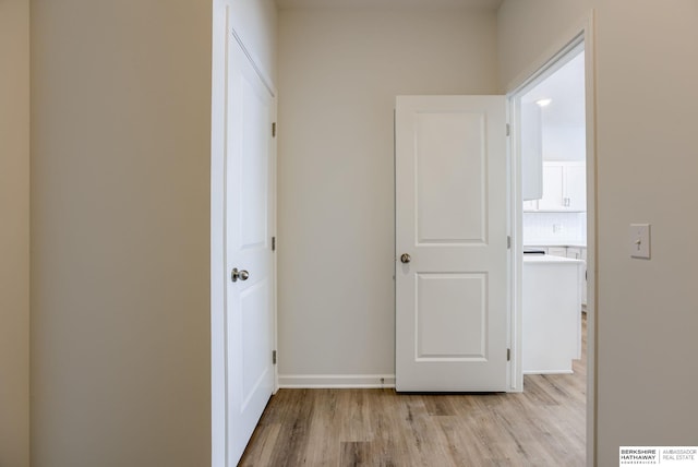 corridor with light hardwood / wood-style flooring