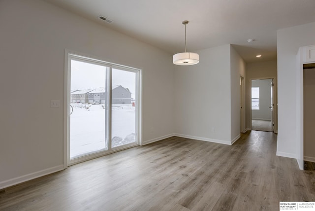 empty room with light hardwood / wood-style flooring