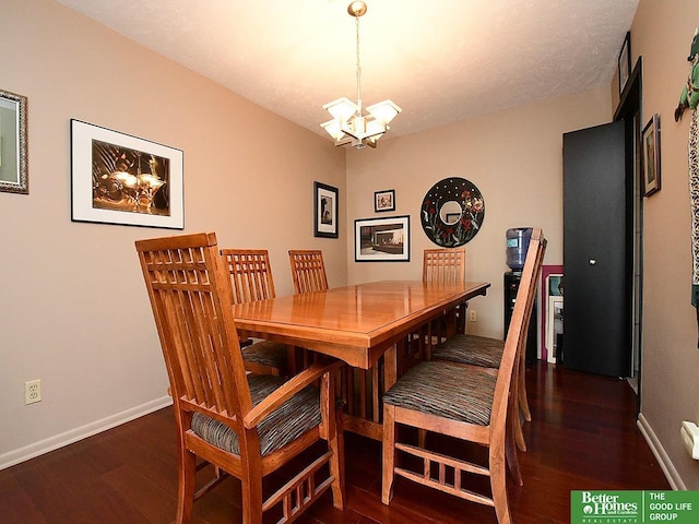 dining area featuring a notable chandelier and dark wood-type flooring