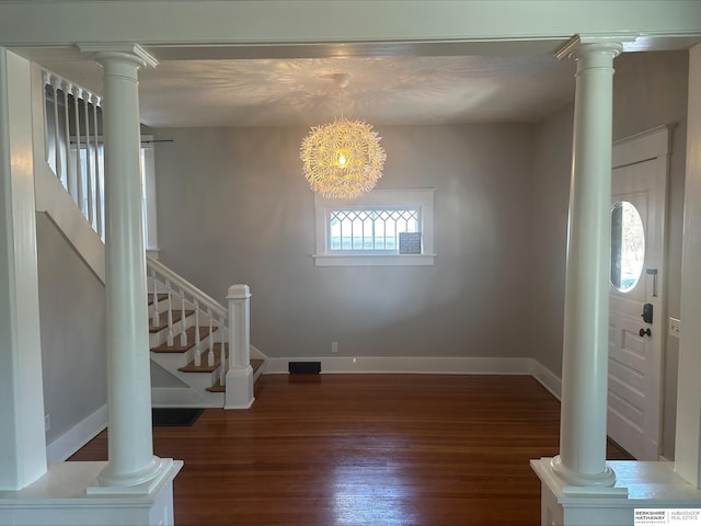 foyer featuring a healthy amount of sunlight, dark hardwood / wood-style floors, and an inviting chandelier