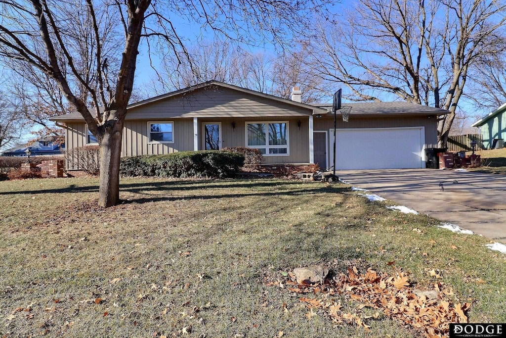 ranch-style house featuring a front lawn and a garage