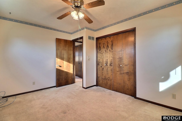 unfurnished bedroom featuring light carpet, a closet, and ceiling fan