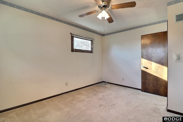 unfurnished room featuring ceiling fan and light carpet