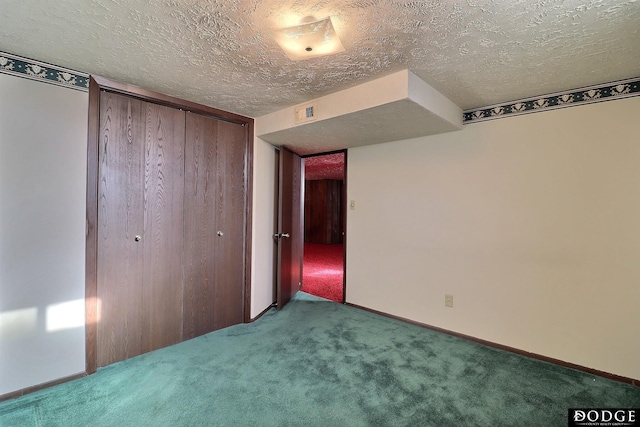 unfurnished bedroom with carpet flooring, a closet, and a textured ceiling