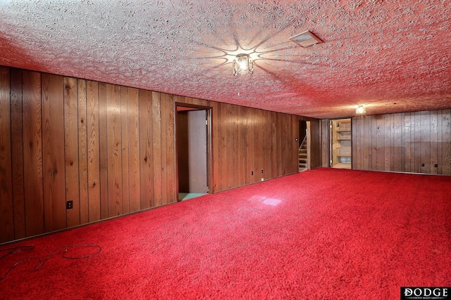 basement featuring wood walls