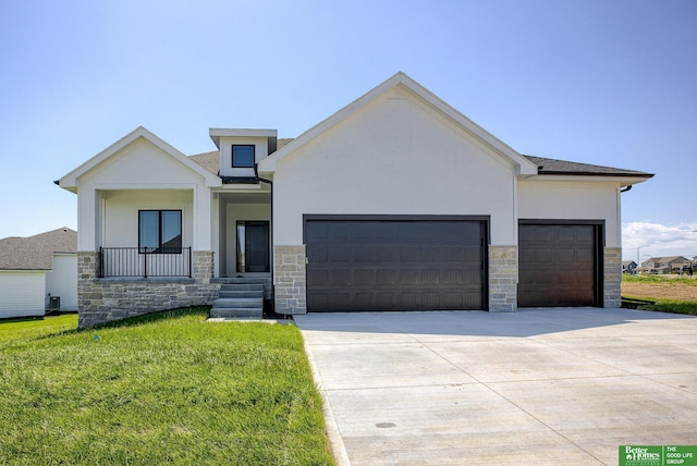 view of front of property featuring a garage and a front lawn