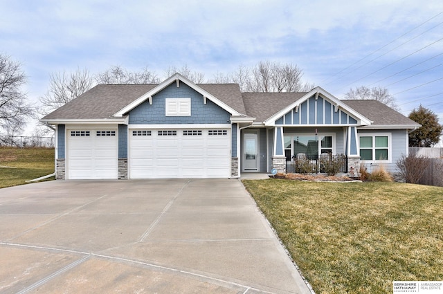 craftsman-style home featuring a porch, a garage, and a front lawn