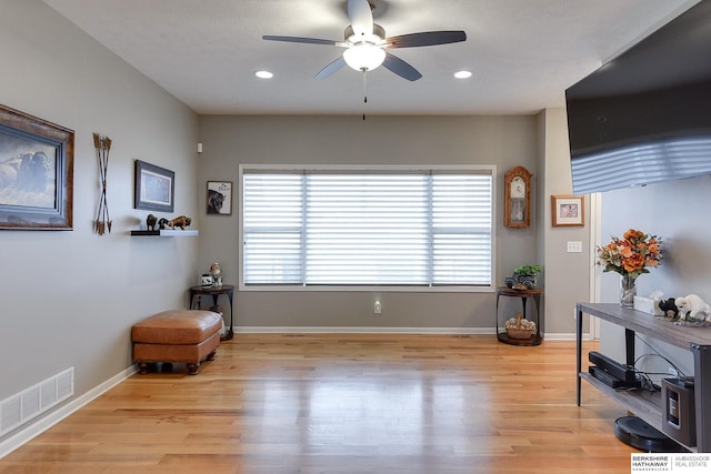 sitting room featuring ceiling fan and light hardwood / wood-style floors