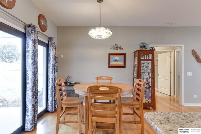 dining space with light hardwood / wood-style flooring