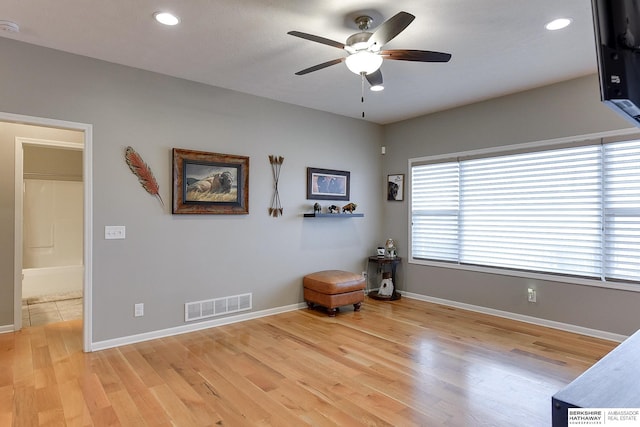 interior space with ceiling fan and light hardwood / wood-style floors