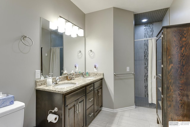 bathroom featuring a shower with curtain, vanity, toilet, and tile patterned flooring