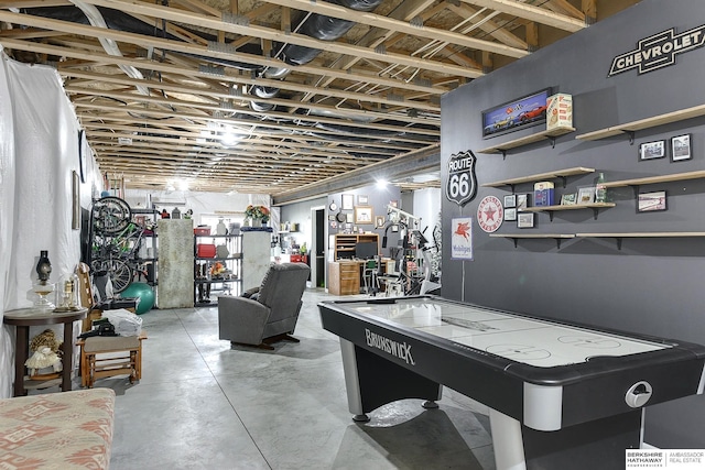 recreation room featuring concrete flooring