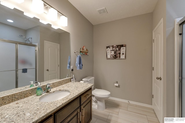 bathroom with vanity, toilet, and an enclosed shower