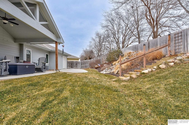 view of yard featuring a patio area and ceiling fan