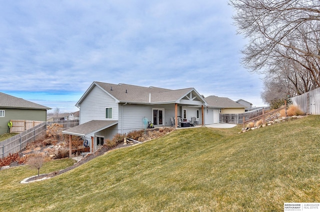 back of property with a lawn and a patio area