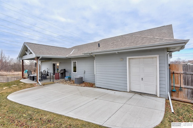 back of house featuring a garage and central air condition unit