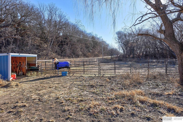 view of yard with a rural view and an outbuilding