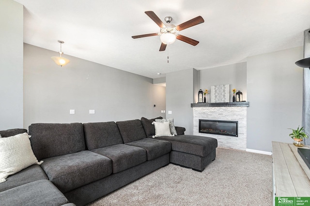 living room featuring carpet, ceiling fan, and a fireplace