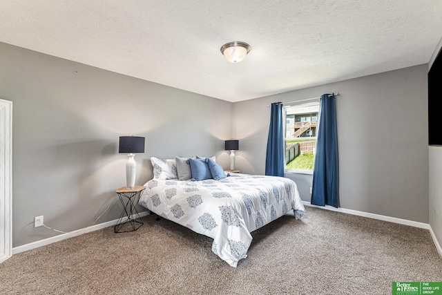 bedroom featuring carpet floors and a textured ceiling