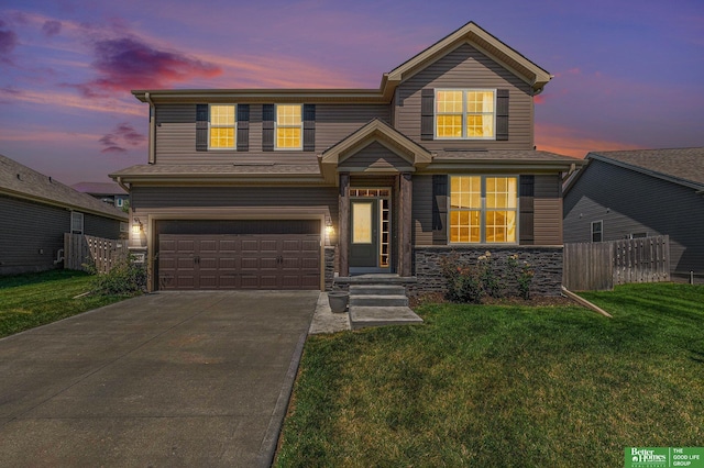 view of front of property with a lawn and a garage