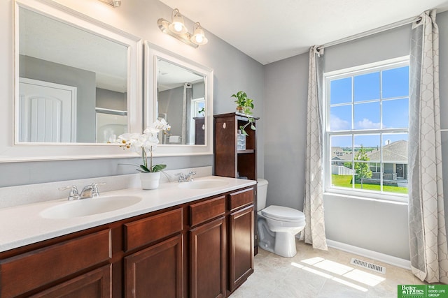 bathroom with tile patterned floors, vanity, and toilet