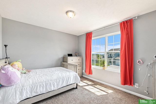 bedroom featuring carpet flooring and a textured ceiling