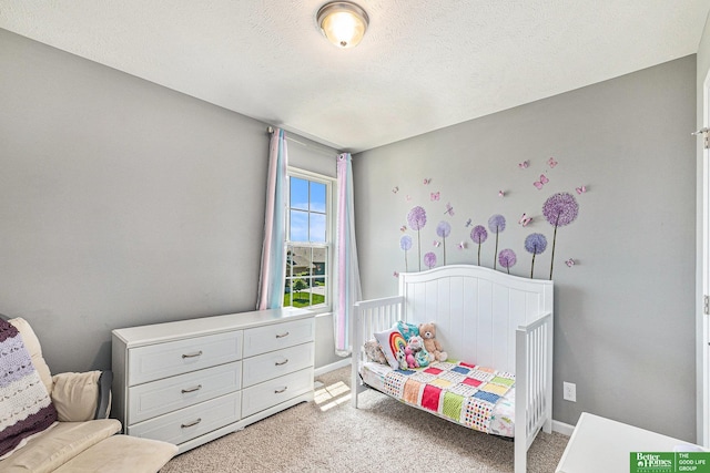 carpeted bedroom with a textured ceiling