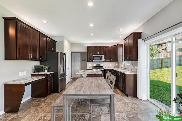 kitchen featuring dark brown cabinetry, sink, and stainless steel appliances