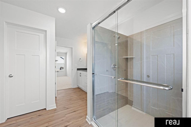 5508 Brook St, Papillion, NE 68133 - bathroom with a stall shower, wood finished floors, vanity, and recessed lighting